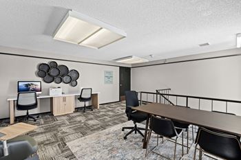 A conference room with a long table and chairs.